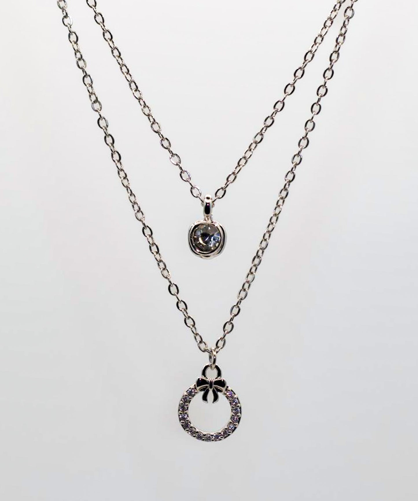 Silver BowCircle Layered Necklace – Dual Chain with Crystal Bow Ring Pendant